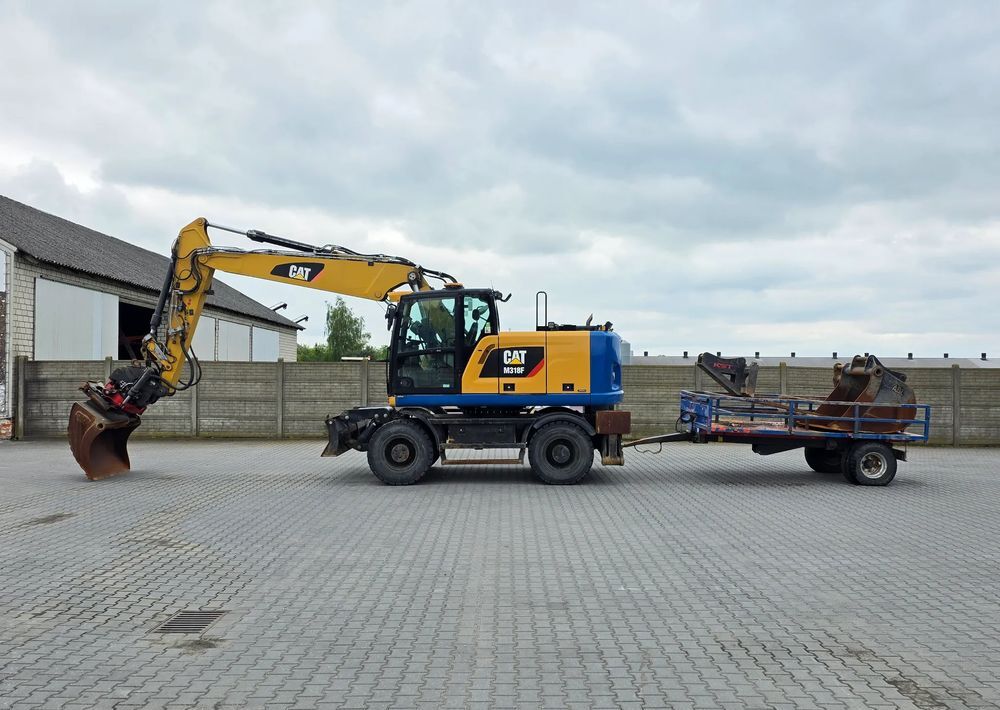 Caterpillar M318F, 2018 ROK, PODPORY + PŁUG, ROTOTILT - Pelle sur pneus: photos 1 Caterpillar M318F, 2018 ROK, PODPORY + PŁUG, ROTOTILT - Pelle sur pneus: photos 1