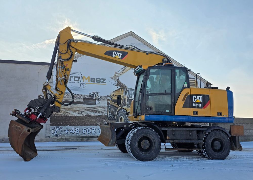 Caterpillar M318F, 2018 ROK, PODPORY + PŁUG, ROTOTILT - Pelle sur pneus: photos 1 Caterpillar M318F, 2018 ROK, PODPORY + PŁUG, ROTOTILT - Pelle sur pneus: photos 1