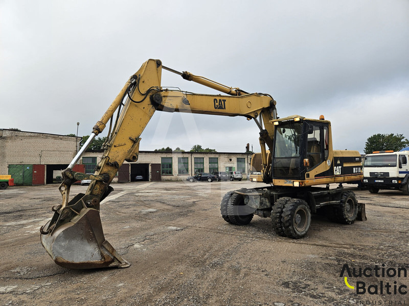 Caterpillar M 318 C - Pelle sur pneus: photos 1 Caterpillar M 318 C - Pelle sur pneus: photos 1