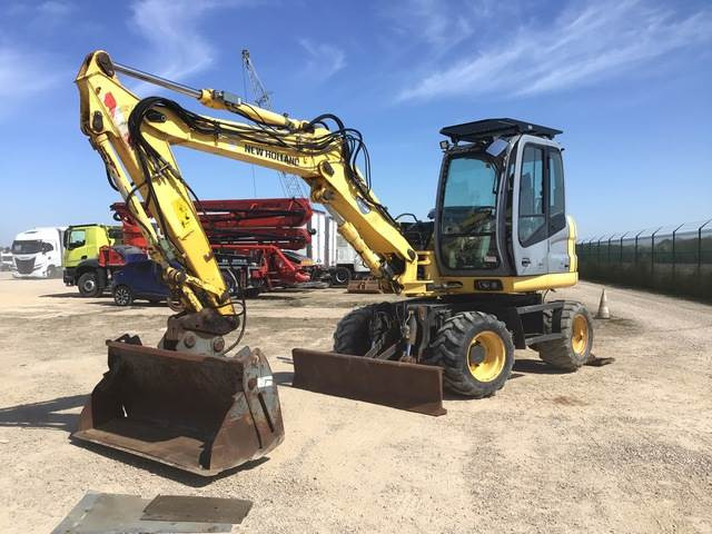 New Holland MH2.6 - Pelle sur pneus: photos 1 New Holland MH2.6 - Pelle sur pneus: photos 1