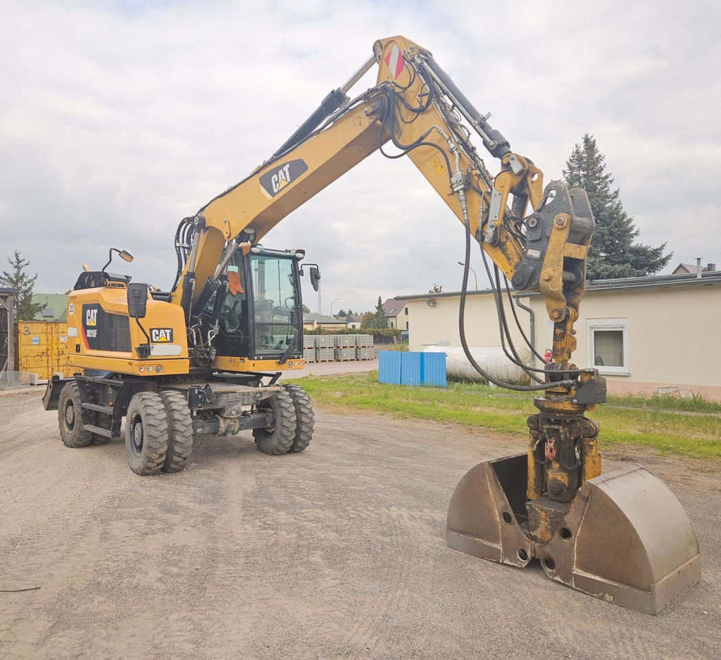 CAT M315F, orig. 2.828h - Pelle sur pneus: photos 1 CAT M315F, orig. 2.828h - Pelle sur pneus: photos 1