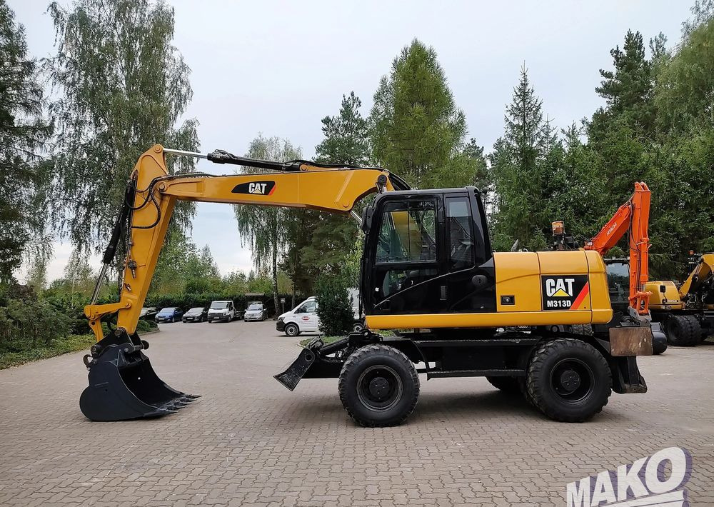Caterpillar M313D - Pelle sur pneus: photos 1 Caterpillar M313D - Pelle sur pneus: photos 1