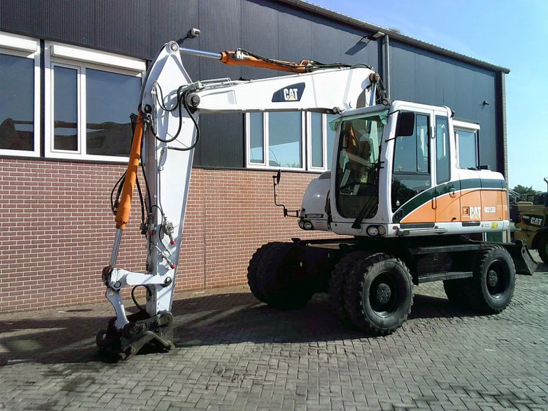 Caterpillar M313D - Pelle sur pneus: photos 1 Caterpillar M313D - Pelle sur pneus: photos 1