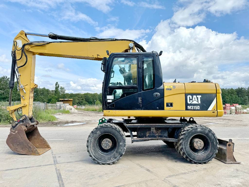 Cat M315D - Triple Boom / Quick Coupler - Pelle sur pneus: photos 1 Cat M315D - Triple Boom / Quick Coupler - Pelle sur pneus: photos 1