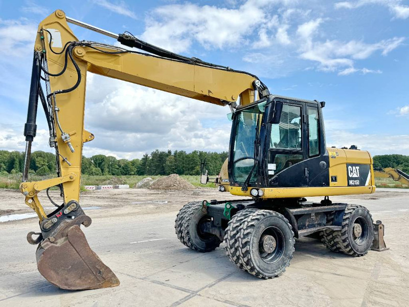 Cat M315D - Triple Boom / Quick Coupler - Pelle sur pneus: photos 2 Cat M315D - Triple Boom / Quick Coupler - Pelle sur pneus: photos 2