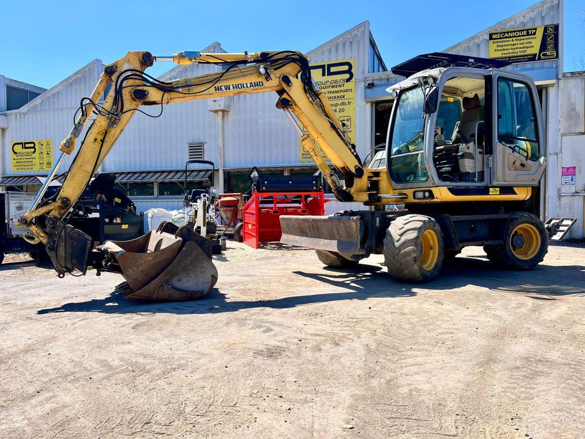 New Holland MH 2.6 PELLE A PNEUS 10T - Pelle sur pneus: photos 1 New Holland MH 2.6 PELLE A PNEUS 10T - Pelle sur pneus: photos 1