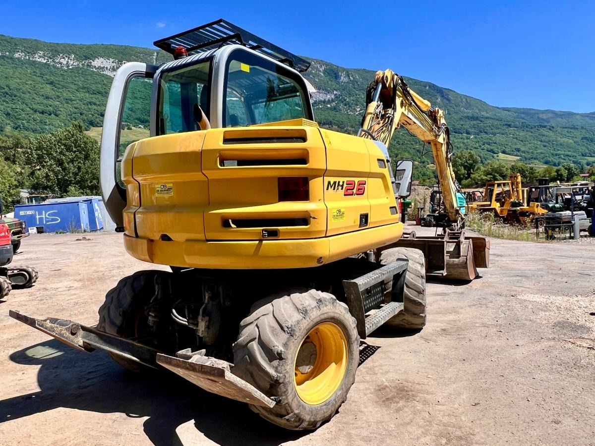 New Holland MH 2.6 PELLE A PNEUS 10T - Pelle sur pneus: photos 4 New Holland MH 2.6 PELLE A PNEUS 10T - Pelle sur pneus: photos 4