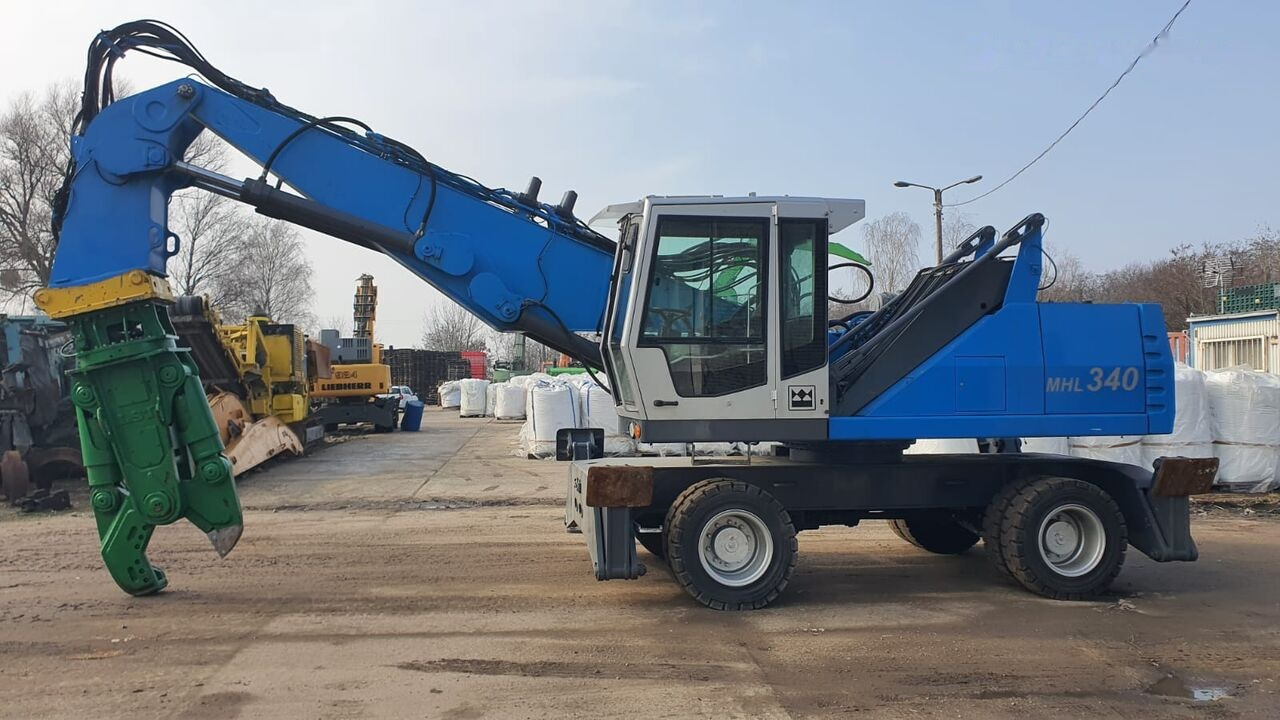 Fuchs MHL 340D FQC + LST 3to shear - Pelle de manutention: photos 1 Fuchs MHL 340D FQC + LST 3to shear - Pelle de manutention: photos 1