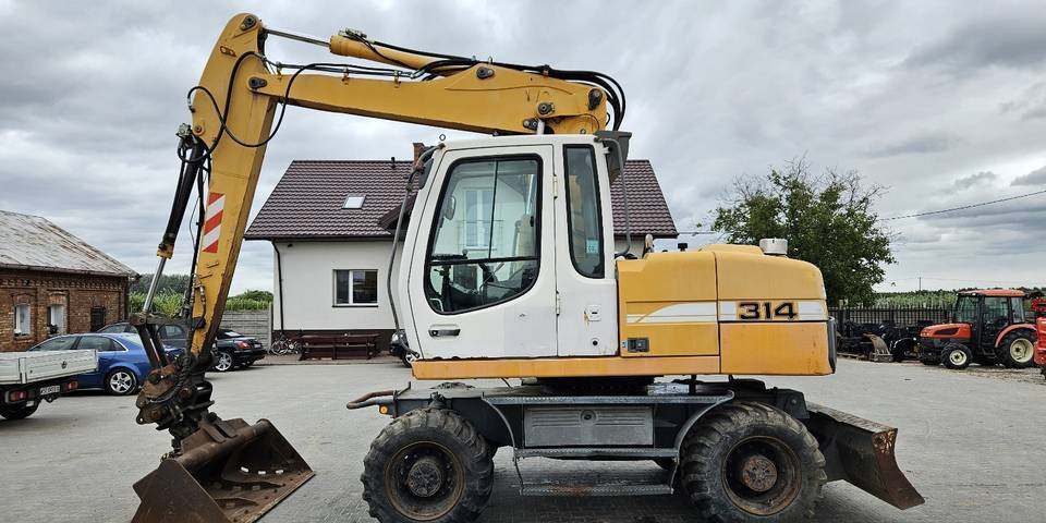 Koparka kołowa Liebherr A314 Litronic 9350 h+ 5 łyżek kołówka - Pelle sur pneus: photos 1 Koparka kołowa Liebherr A314 Litronic 9350 h+ 5 łyżek kołówka - Pelle sur pneus: photos 1