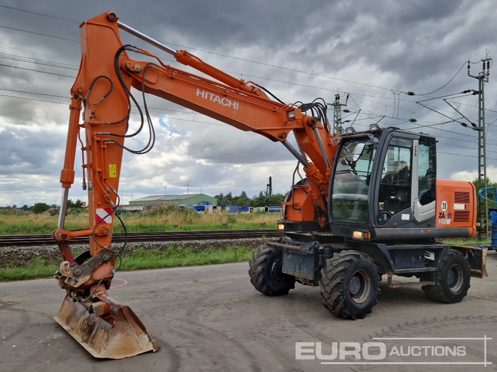 2010 Hitachi ZX140W-3 - Pelle sur pneus: photos 1 2010 Hitachi ZX140W-3 - Pelle sur pneus: photos 1